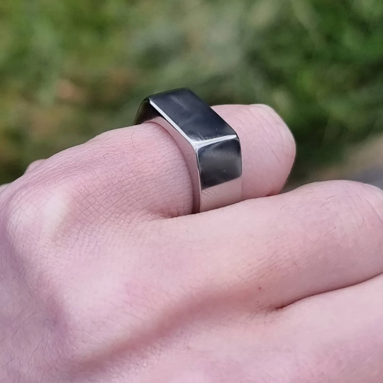 titanium signet ring on pinky finger